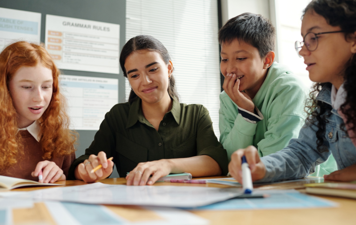Students working through a disagreement together at a table